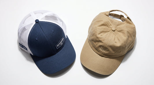 Structured trucker hat and unstructured dad hat side by side — custom branded caps comparison
