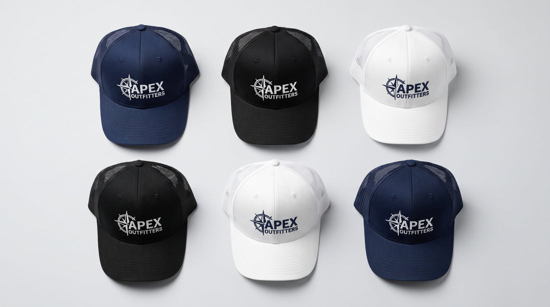 Flat lay of custom embroidered trucker hats in navy, black, and white on a clean surface