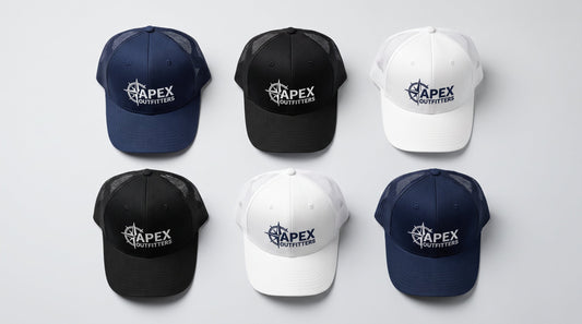 Flat lay of custom embroidered trucker hats in navy, black, and white on a clean surface