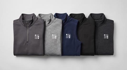 Five custom fleece garments for company logo programs - a soft shell quarter-zip, heather fleece quarter-zip, navy fleece vest, textured black pullover and dark heather full-zip fleece jacket, each with an embroidered left-chest emblem