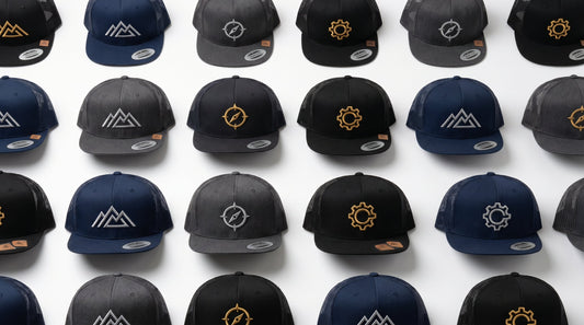 Custom embroidered flat bill trucker hats in navy black and charcoal for business branding