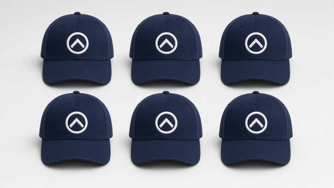 Six navy blue caps with a matching white embroidered logo, a bulk embroidered hat order