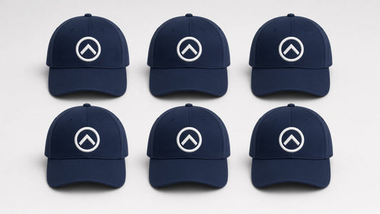 Six navy blue caps with a matching white embroidered logo, a bulk embroidered hat order