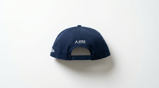 New Era wholesale snapback cap on white surface — professional branded merchandise product photography