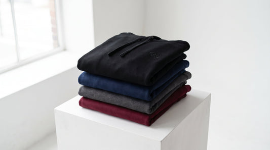 Custom branded hoodies stacked in bulk for business orders